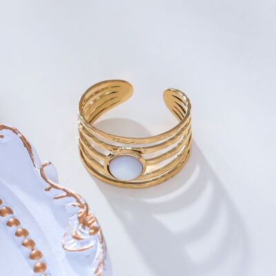 Golden lines ring with white stone