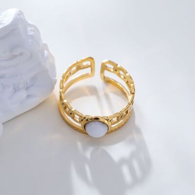 Golden braid lines ring with white stone