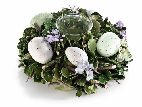 Centro tavola di uova pasquali e fiori con vasetto portacandela in vetro