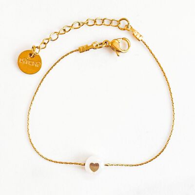 Golden heart bracelet on mother-of-pearl