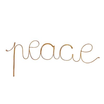 Golden brass wire word PEACE