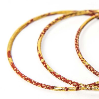 Feine Armbänder aus rotem und goldenem Wachs