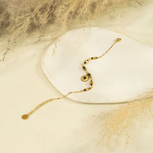 Bracelet chaîne dorée avec détails noirs et pendentif fleur