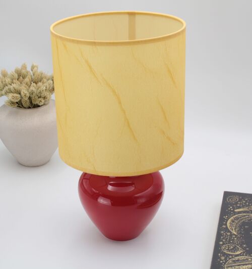 Red table lamp with parchment style fabric shade
