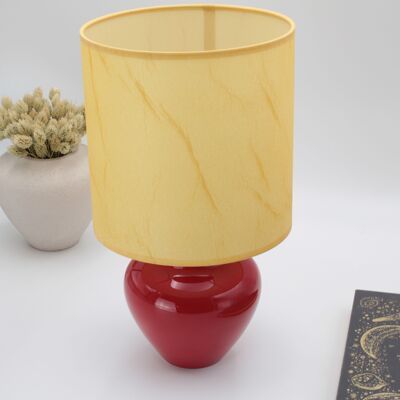 Red table lamp with parchment style fabric shade