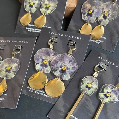 Earrings and purple pansy flowers