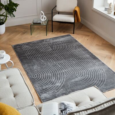 Low pile rug with half arc pattern in gray relief