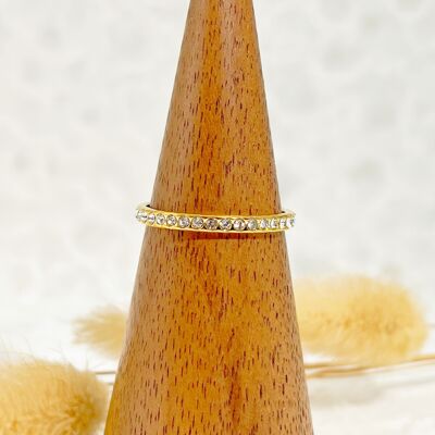 Simple golden ring surrounded by rhinestones