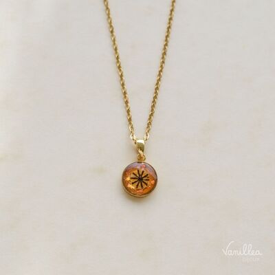 Necklace made of natural Poppy flowers on a plain orange background in gold stainless steel