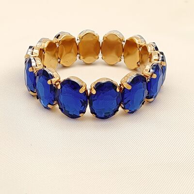 Goldenes elastisches Armband mit blauen Strasssteinen