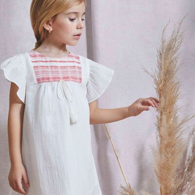 White girl's dress with coral striped fabric on the front K24-29405161