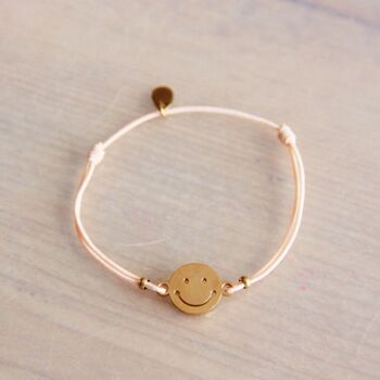 Bracelet élastique avec smiley – pêche/or 1