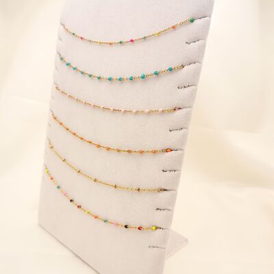 Set of 6 colorful golden necklaces on display