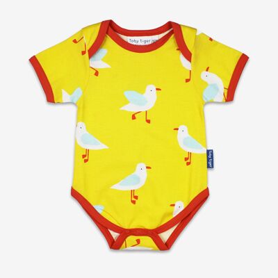 Body para bebé confeccionado en algodón orgánico de color amarillo con estampado de gaviotas