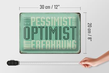 Plaque en étain disant 30x20cm Le pessimiste est optimiste avec 4