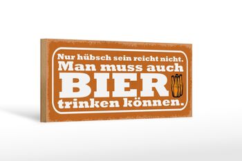 Panneau en bois indiquant que 27x10 cm n'est pas suffisant pour boire de la bière 1