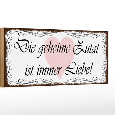 Cartello in legno da 27x10 cm con scritta "L'ingrediente segreto è sempre l'amore".