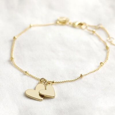 Falling Double Hearts on Satellite chain bracelet in gold plate