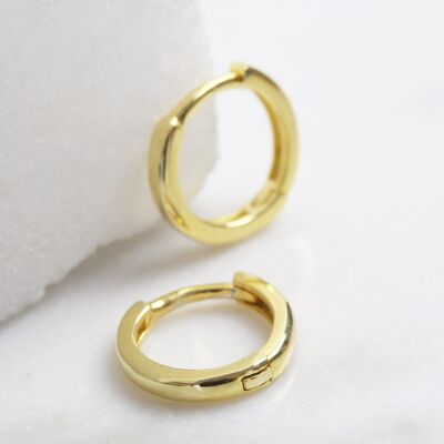 Small hoop sterling huggie earrings with gold plate.