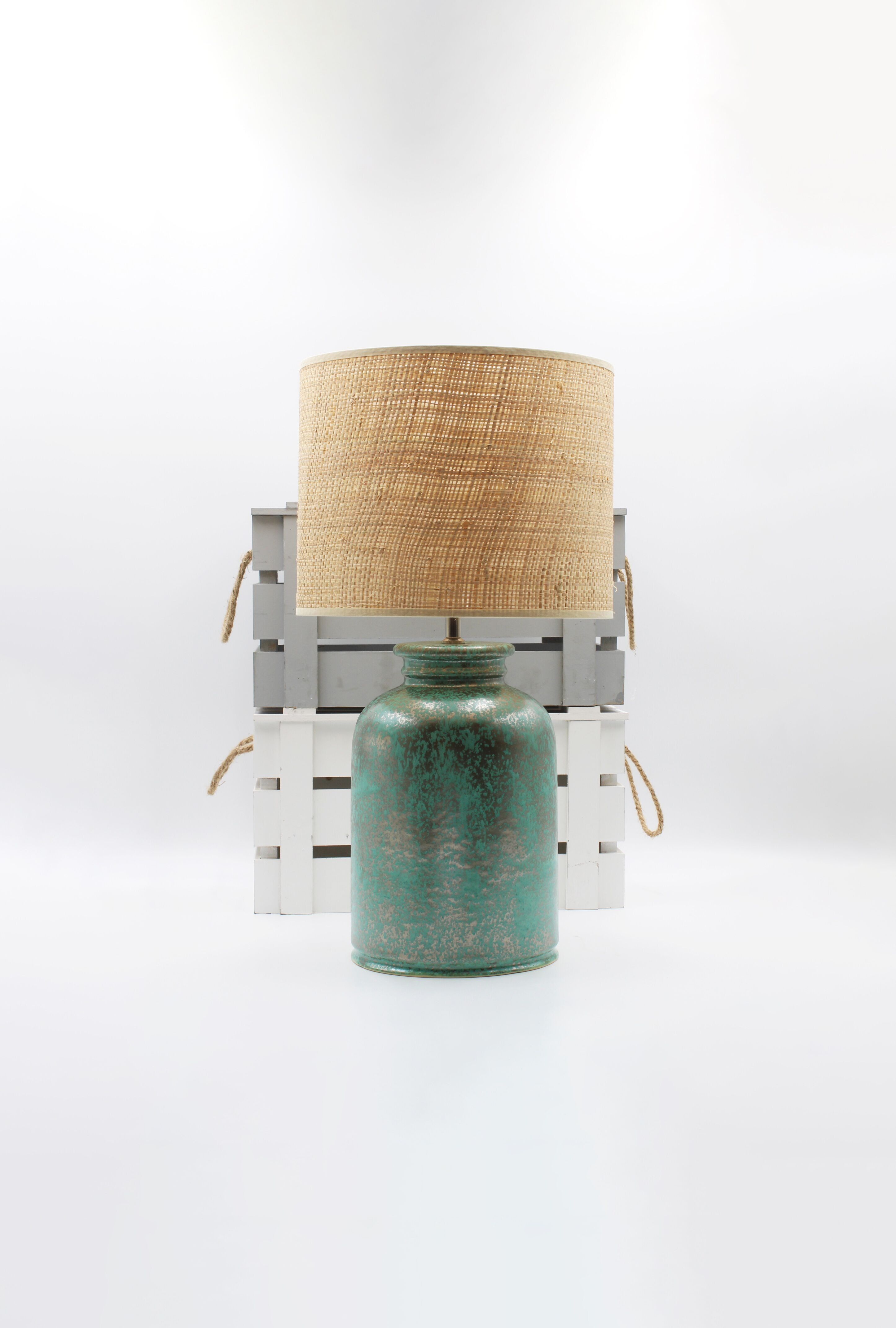 Green ceramic table lamp with metallic - silvery/antique golden flows with Rafia/rattan drum shade.