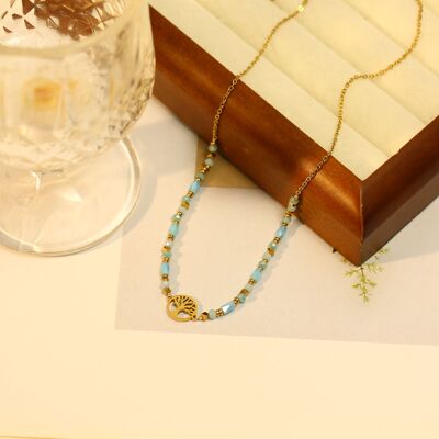 Collana dorata con pendente ad albero e pietra naturale blu