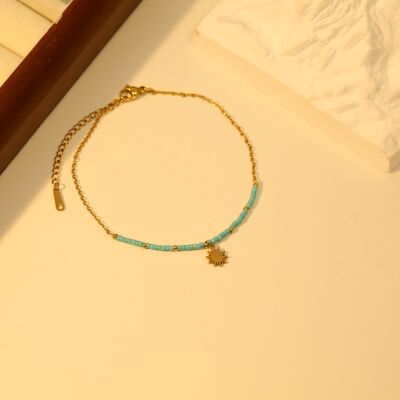 Chaîne de cheville dorée avec perles bleues et pendentif soleil