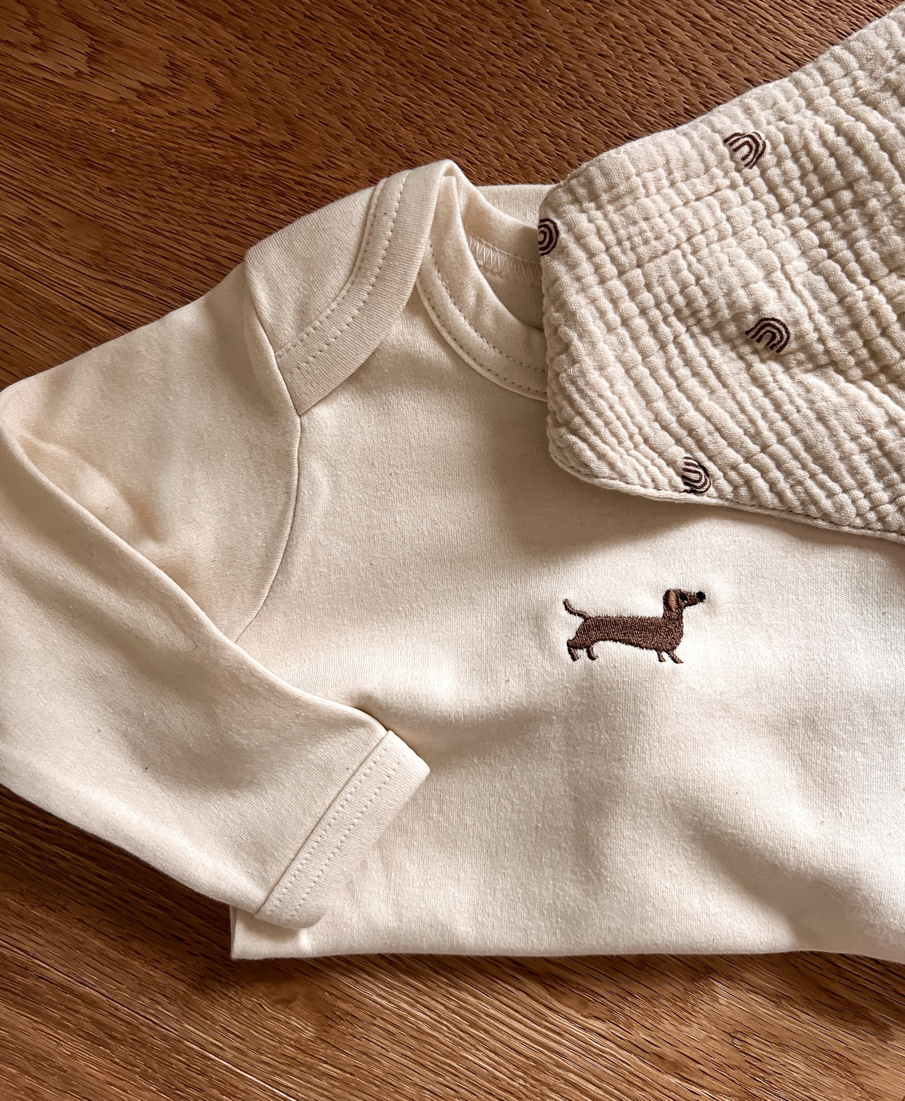 Body bebè con ricamo bassotti