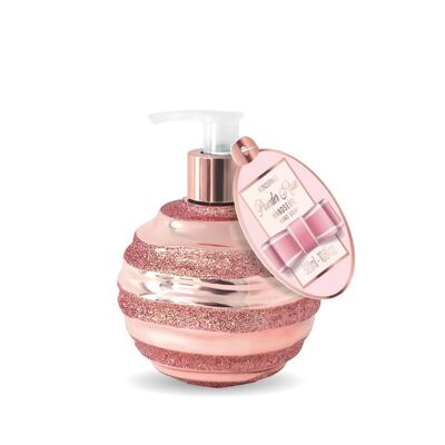 Savon liquide pour les mains dans un distributeur avec des paillettes roses