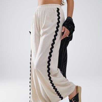 Pantalones de lino avec côtes festoneado en contraste en beige