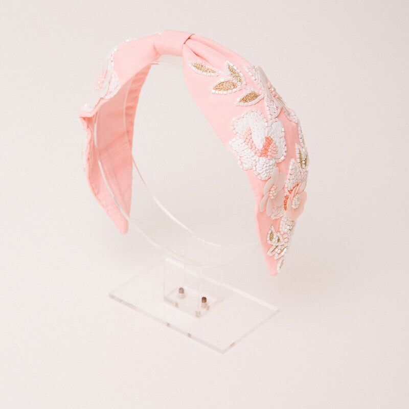 Fascia per capelli rosa Kota con fiori bianchi