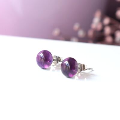 Shiny earrings in purple glass