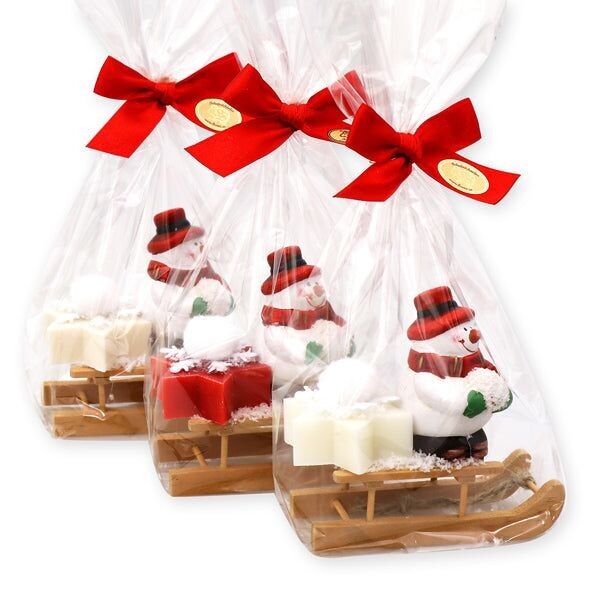 Schafmilchseife Stern midi 20g, dekoriert mit Schneemann auf Holzschlitten in Cello, sortiert