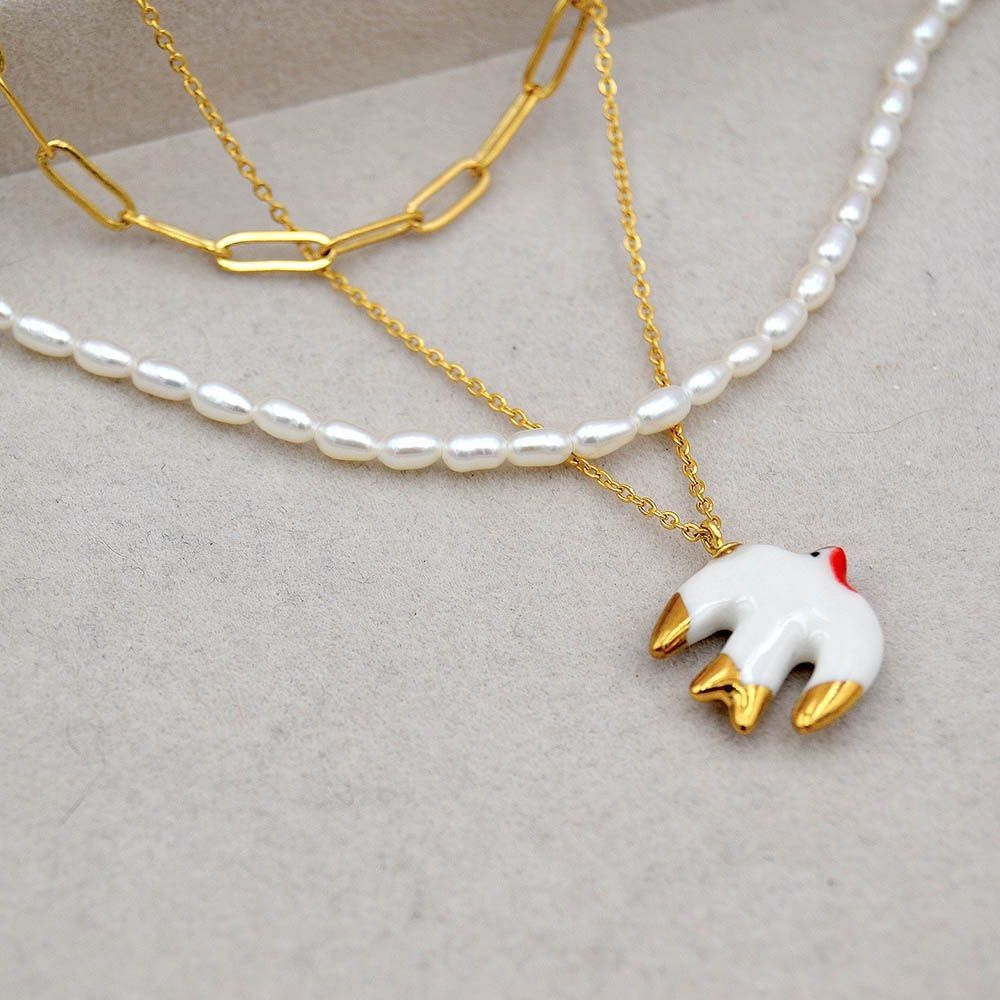 Ciondolo rondine in porcellana decorato in oro