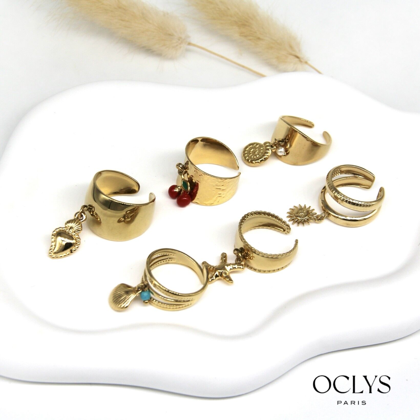 Lot of 12 golden stainless steel rings with Sopi charms