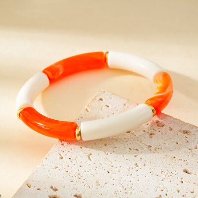 Pulsera elástica de resina color marfil y naranja.