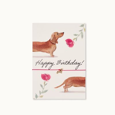 Biglietto d'auguri con braccialetto: Buon compleanno, cane bassotto con fiori