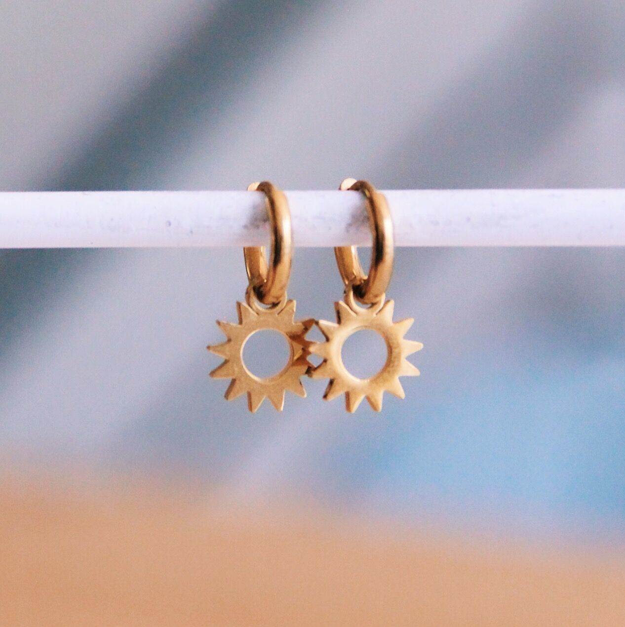 Stainless steel hoop earrings with open sun
