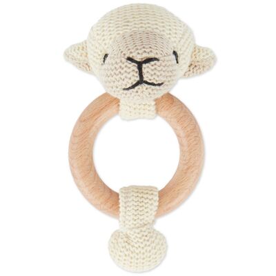 Grasping toy sheep with rattle