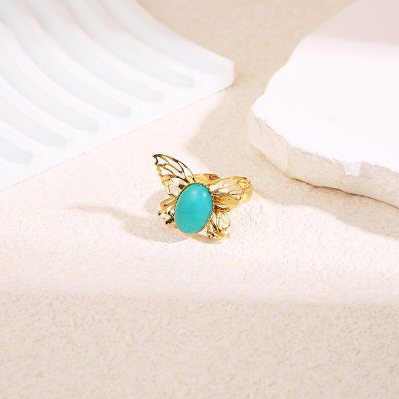 Anello a farfalla in oro con pietra blu