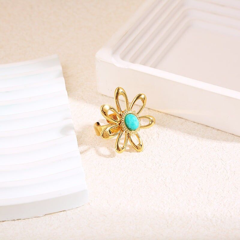 Grande anello a forma di fiore dorato con pietra blu