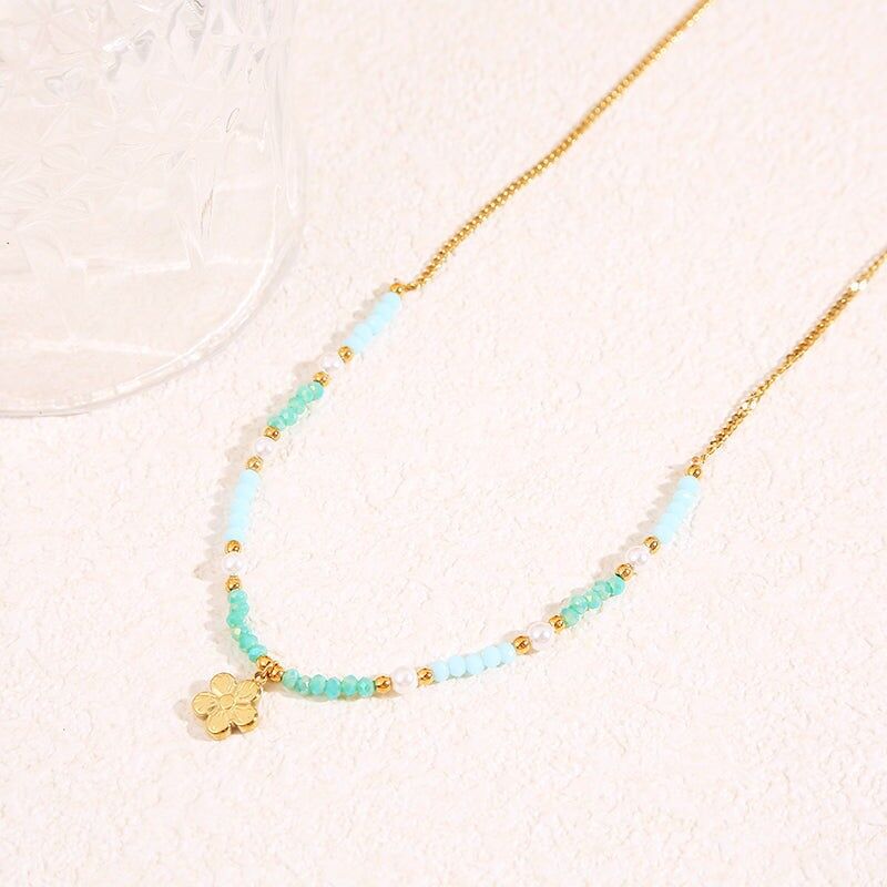 Collana in oro con cristalli blu e ciondolo a forma di fiore