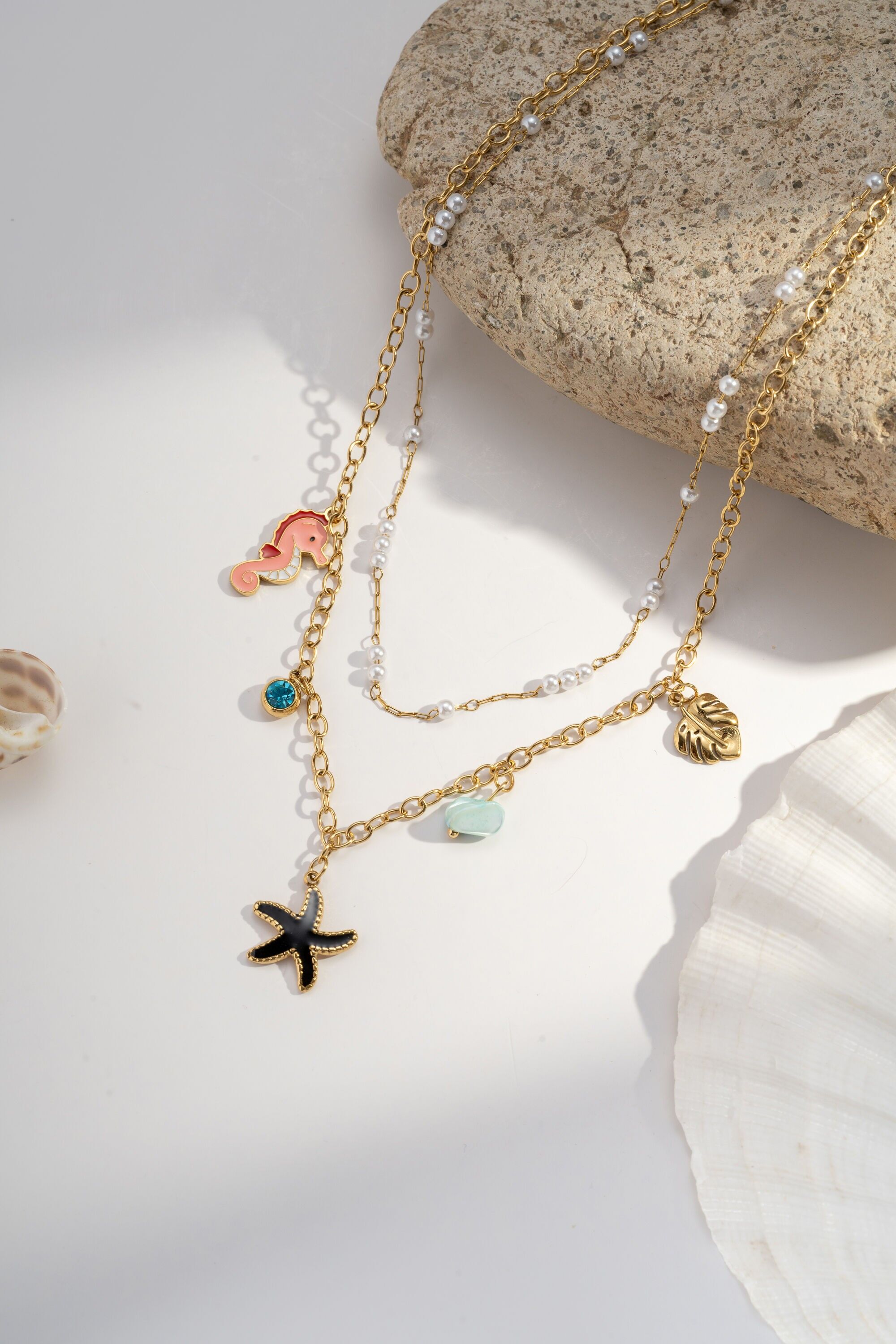 Double-wrapped marine necklace – black starfish, seahorse, stone & pearl – gold-plated stainless steel