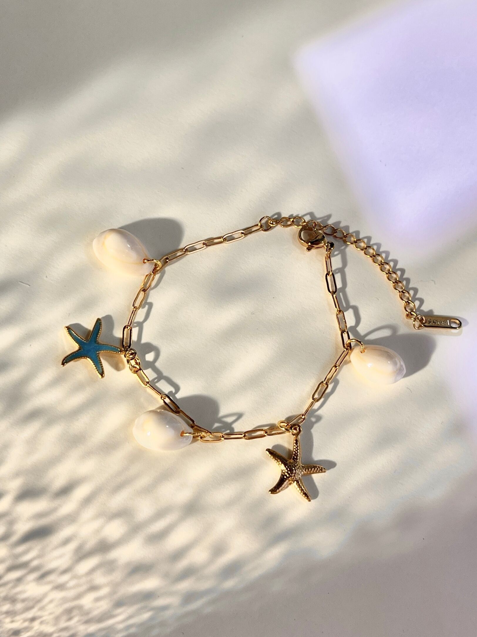 Stainless steel shell and star charm bracelet