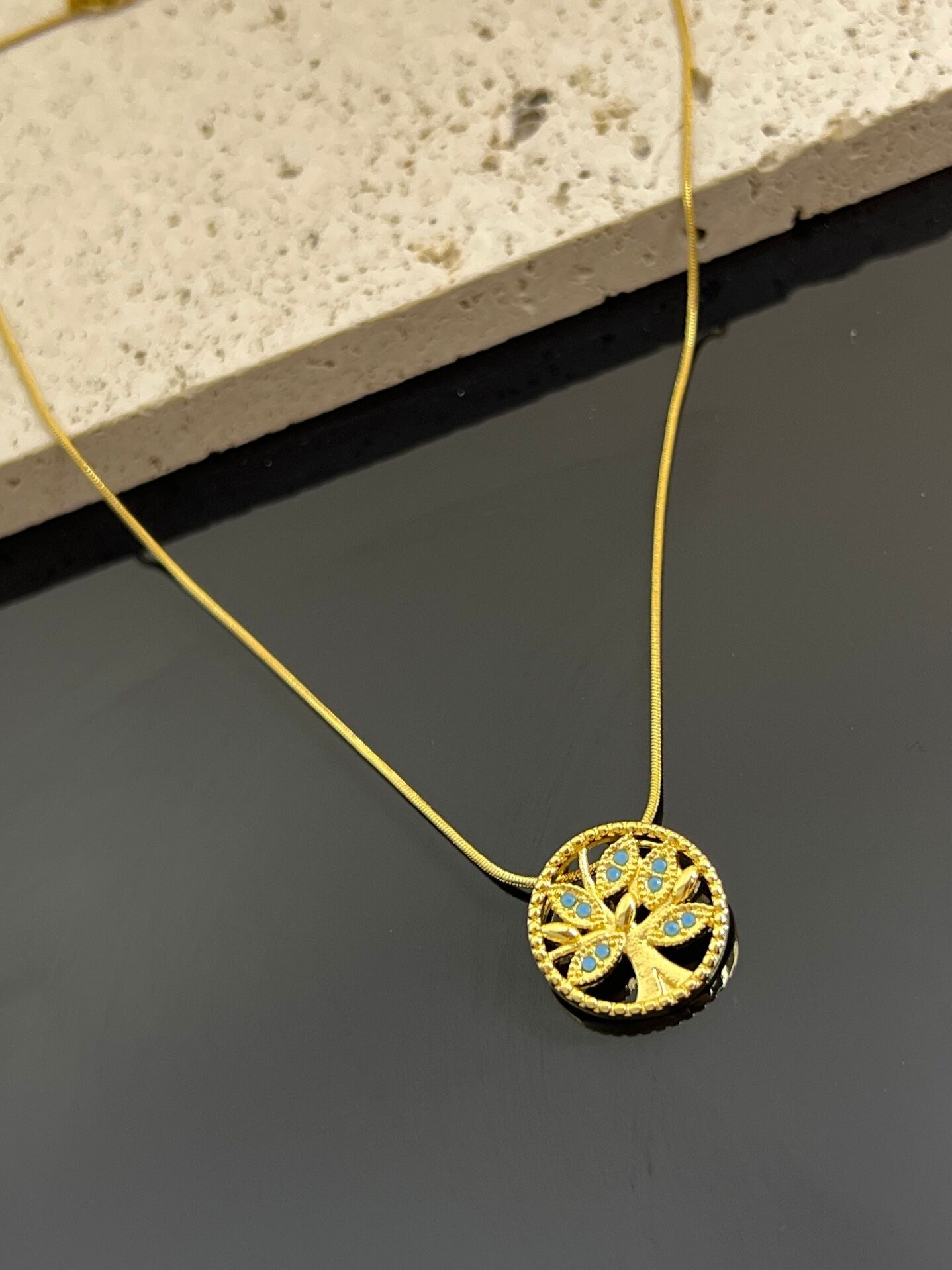 Tree of Life necklace with small blue stone in steel