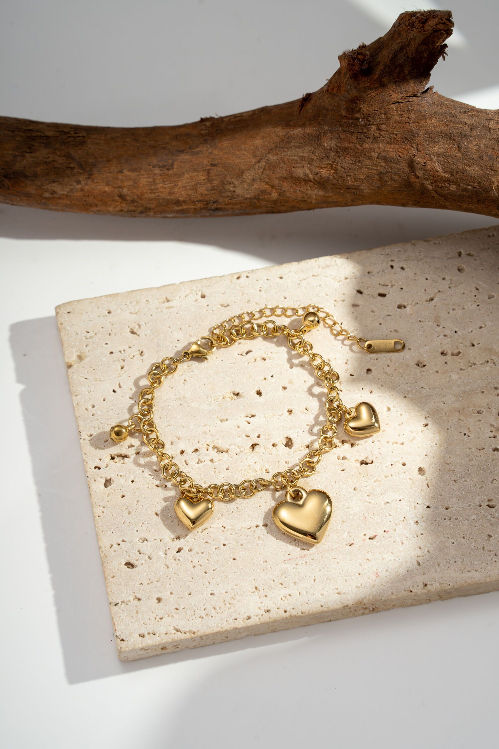 Wide gold link bracelet with steel heart charm