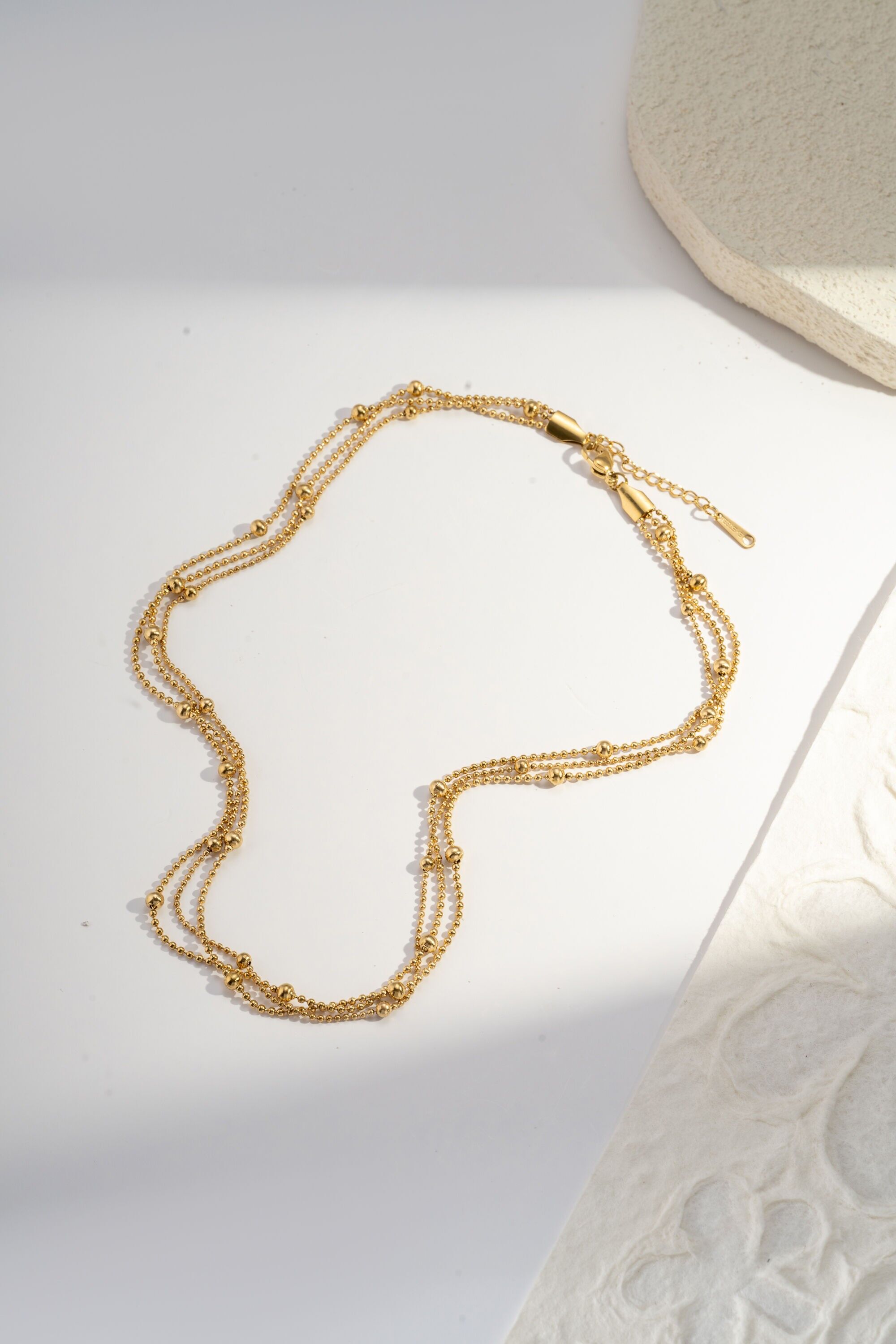 Gold-plated stainless steel necklace with fine round beads, triple wrap