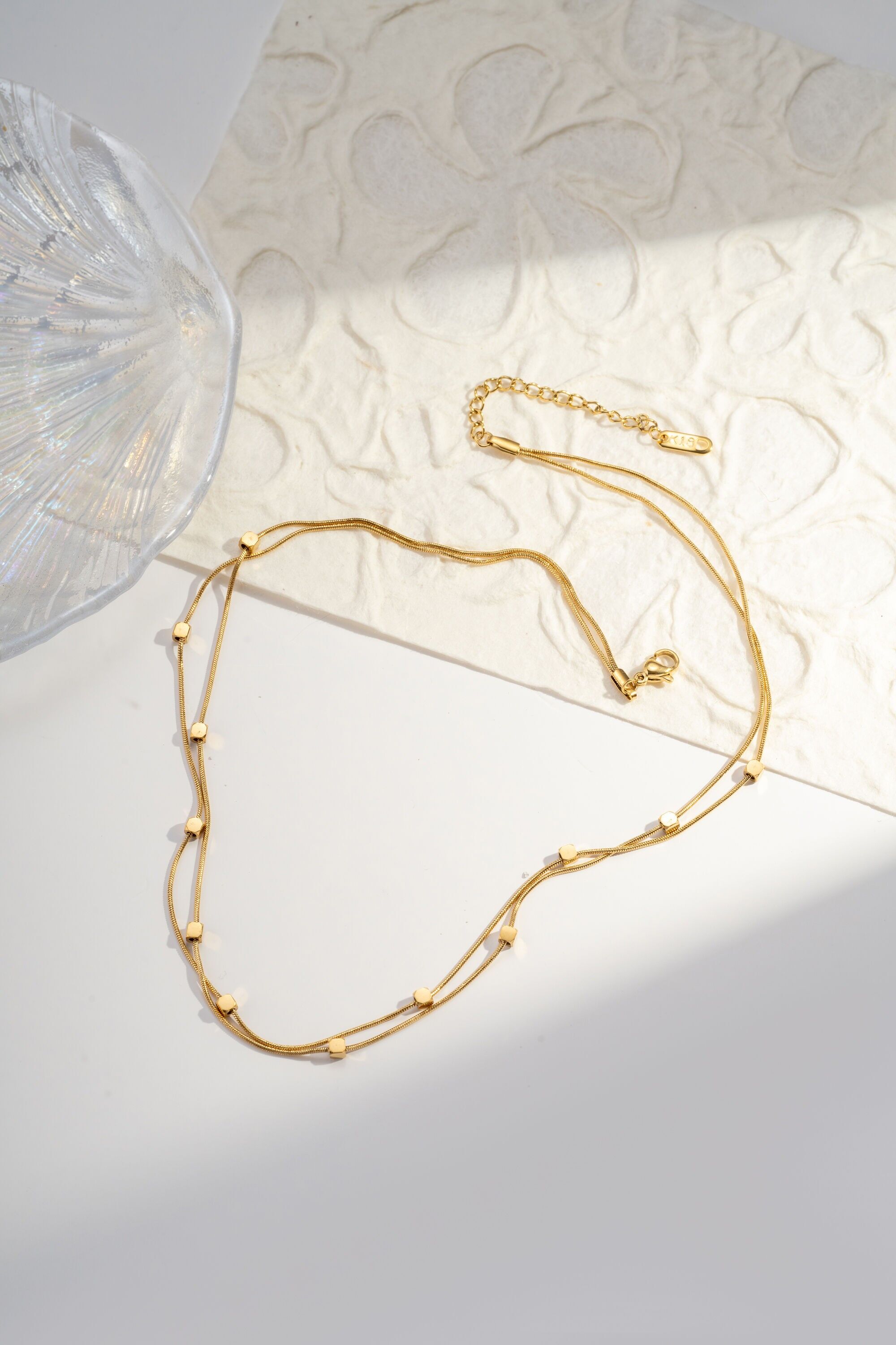 Double-turn steel necklace with small minimalist square pendant