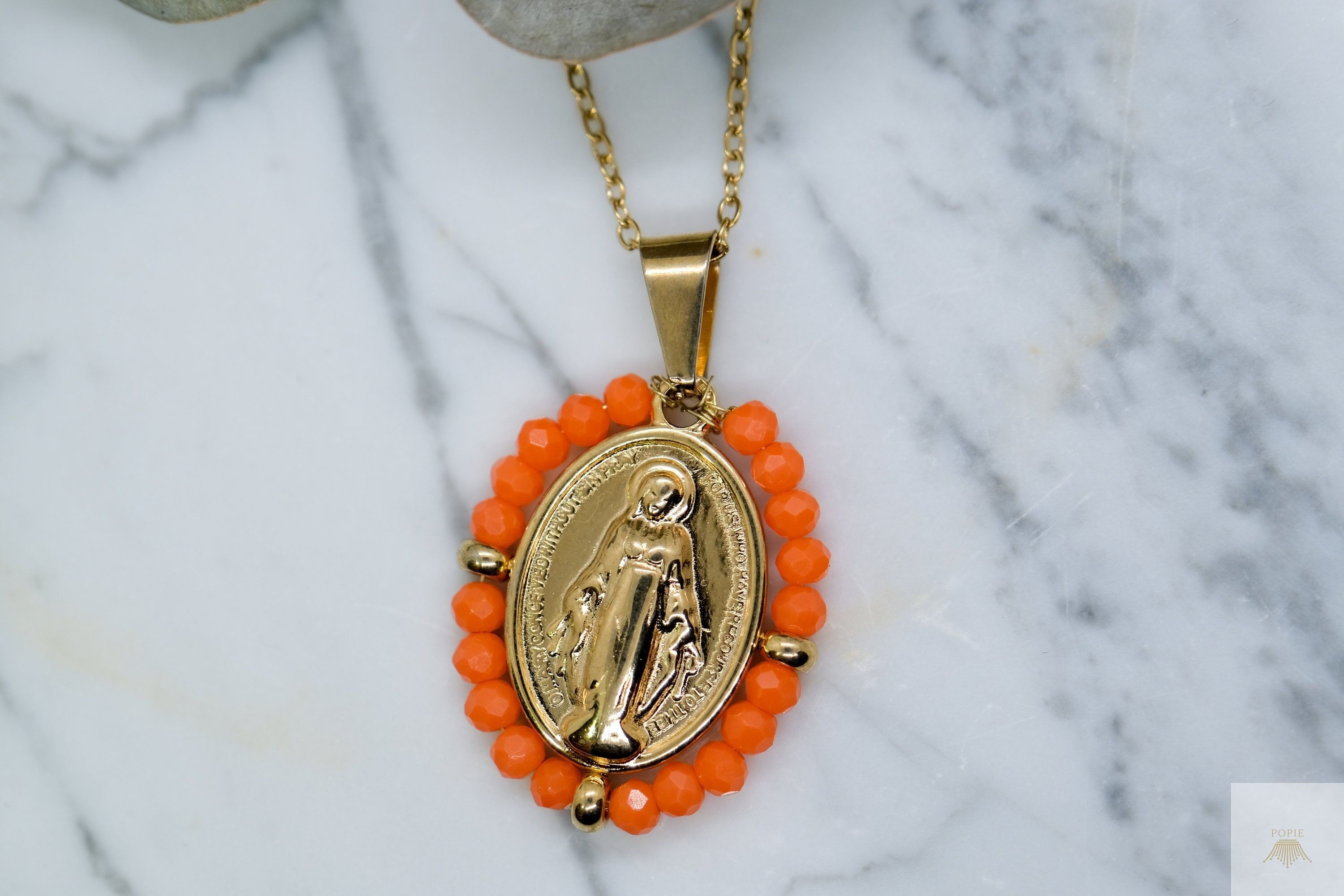 Our Lady necklace surrounded by orange beads