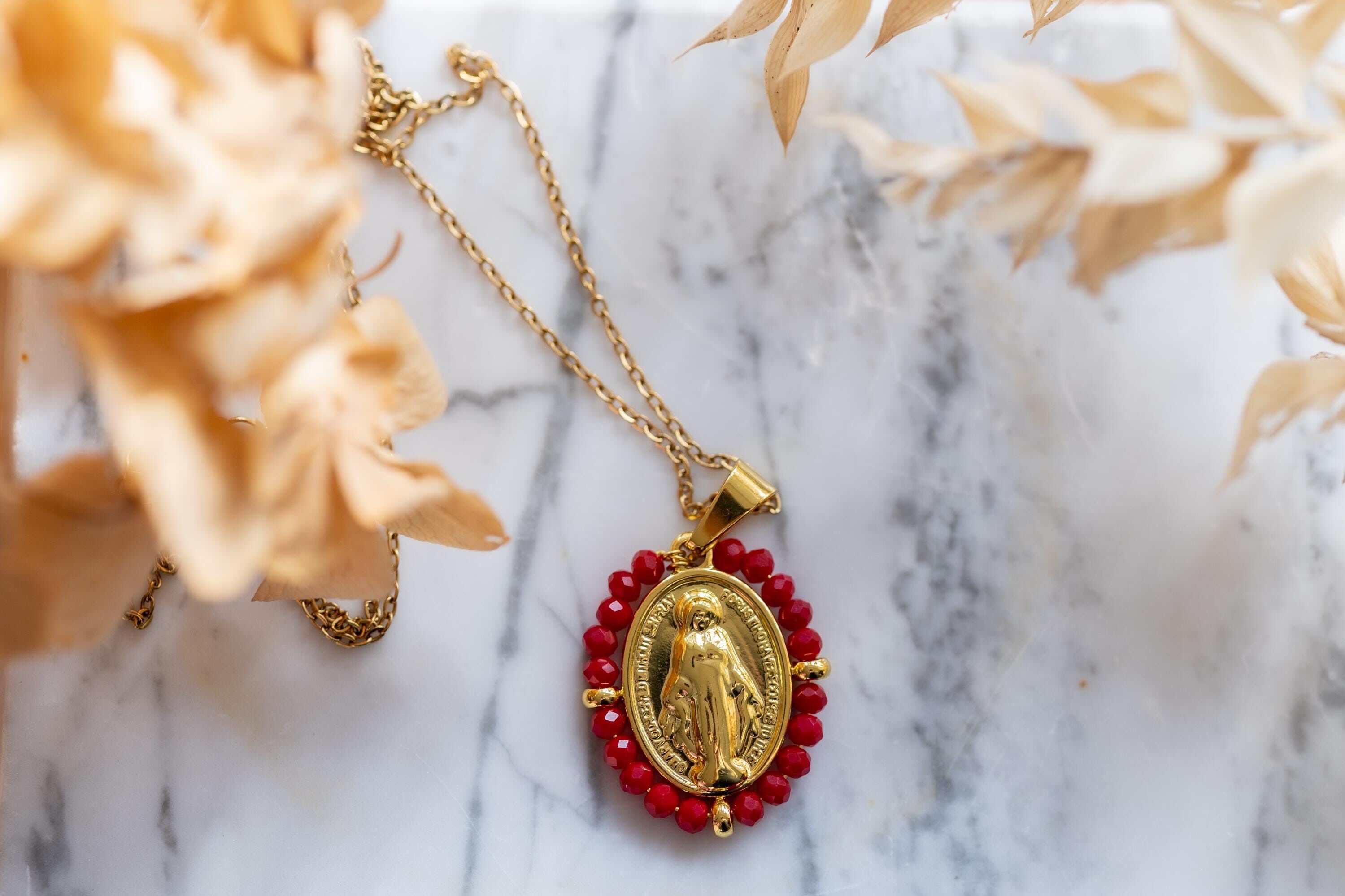 Our Lady necklace surrounded by red pearls