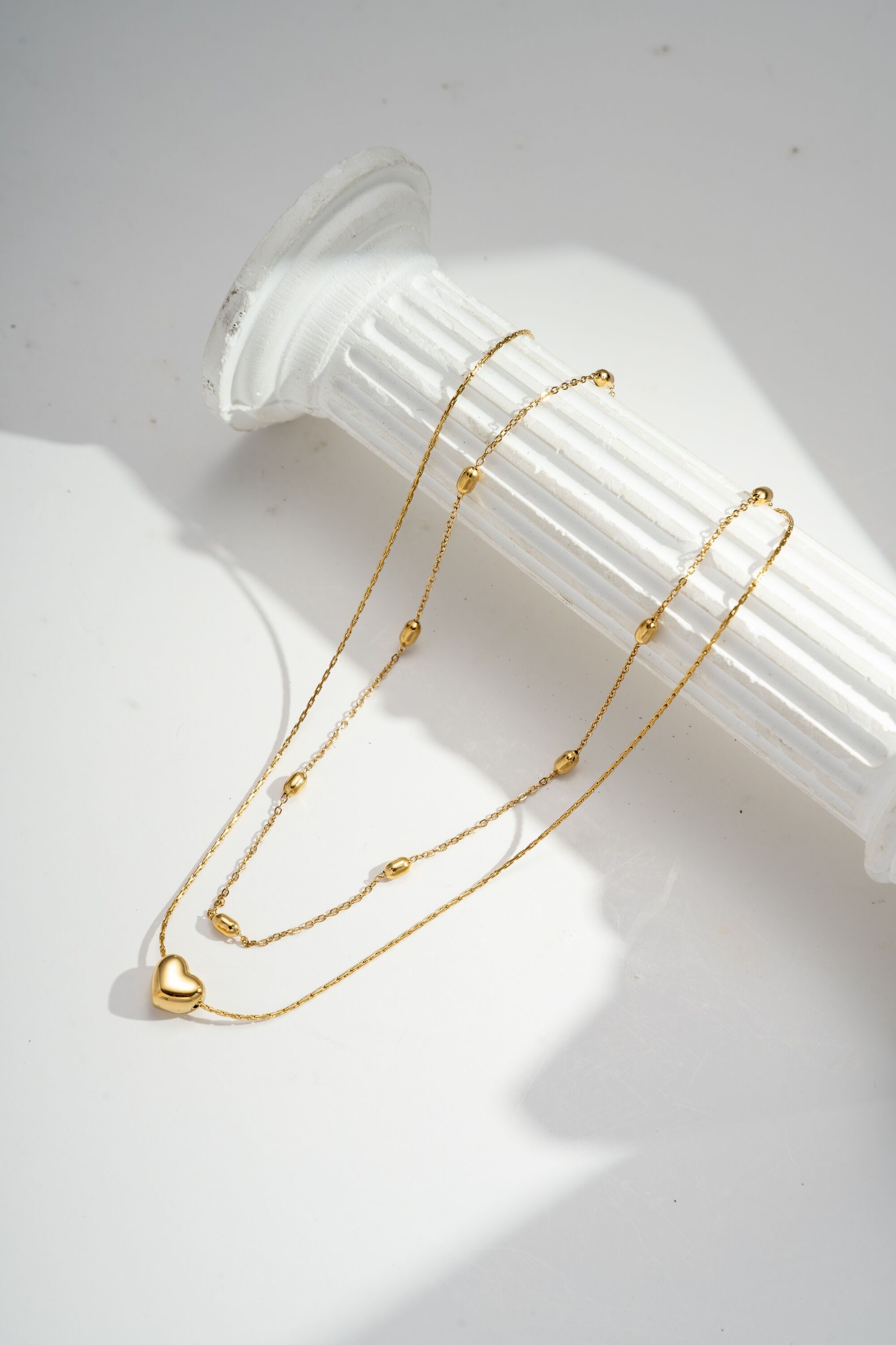Double-wrapped gold heart necklace in stainless steel